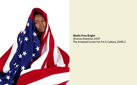 Girl with American flag draped over her.