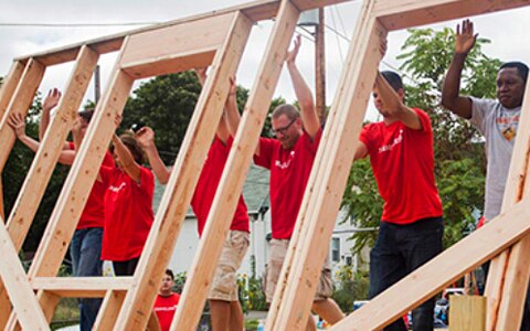 Volunteers building a house.